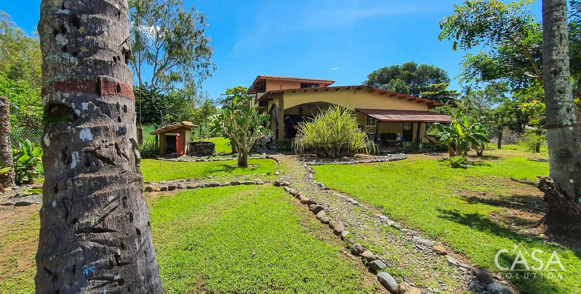 Property for sale in Playa Las Lajas: home with 3 apartments, lagoon access, and tropical garden