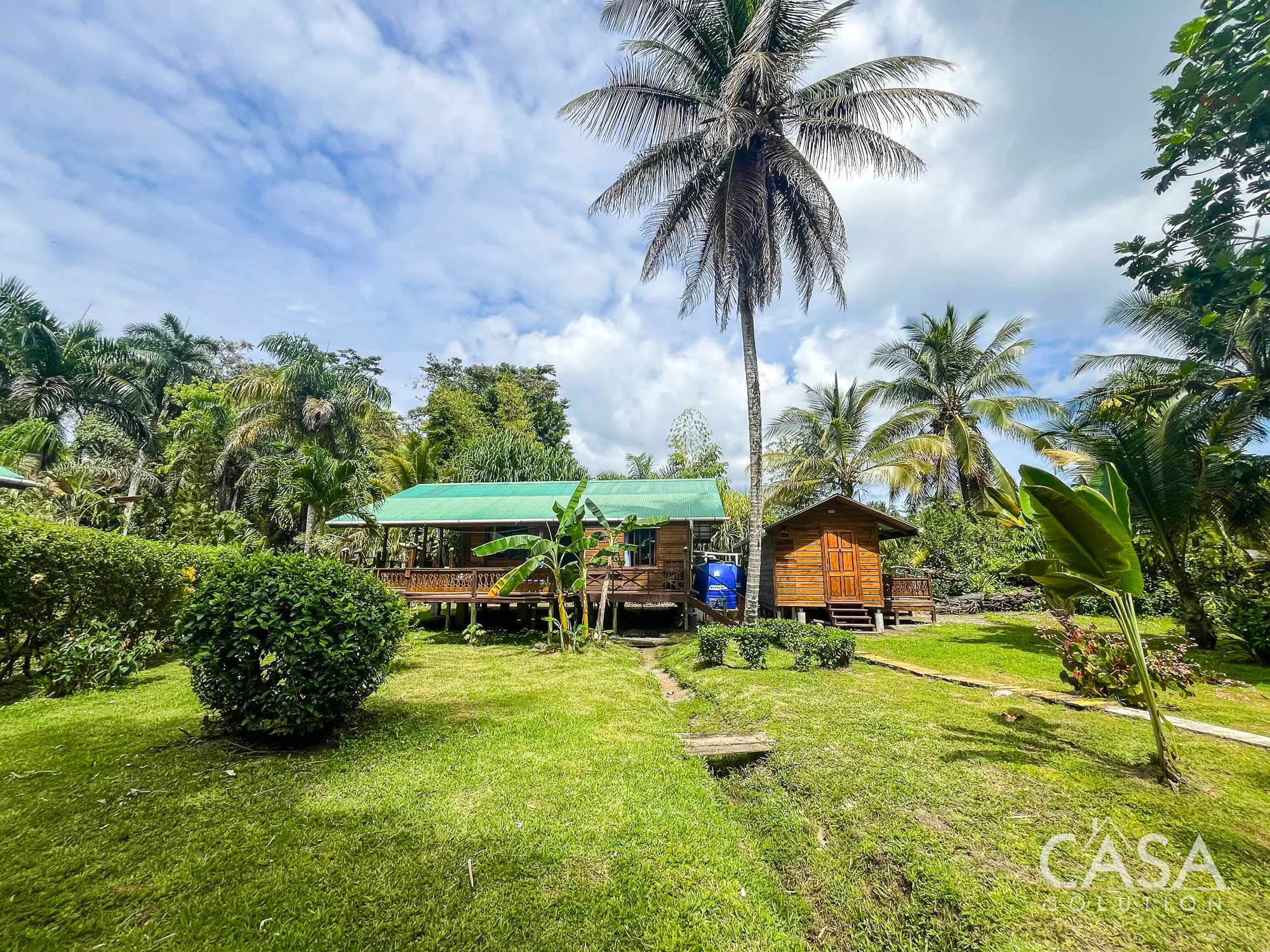 Wooden Cabin for sale in Carenero, Bocas del Toro with 2 bedrooms, terrace, and lush garden