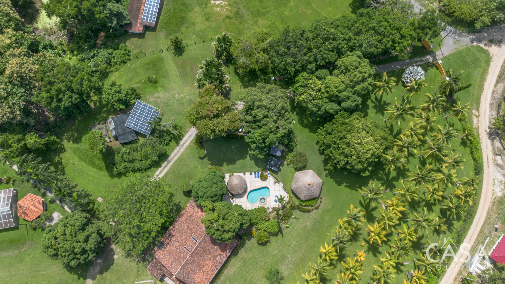 Eco-friendly 15+ hectare estate for sale in San Carlos, Panama West, with a Spanish-style villa, two guest houses, mature teak trees, fruit orchards, workshops, and sustainable infrastructure